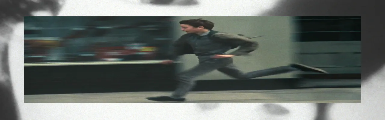 Film still showing a figure in black clothing suspended or leaping horizontally across an architectural interior with motion blur.