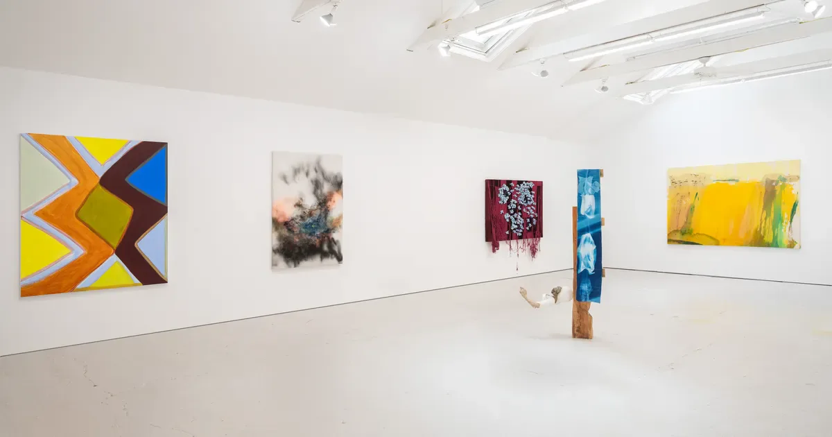 Bright white gallery interior at HESSE FLATOW with polished concrete floor, track lighting, and five artworks displayed on walls and floor.