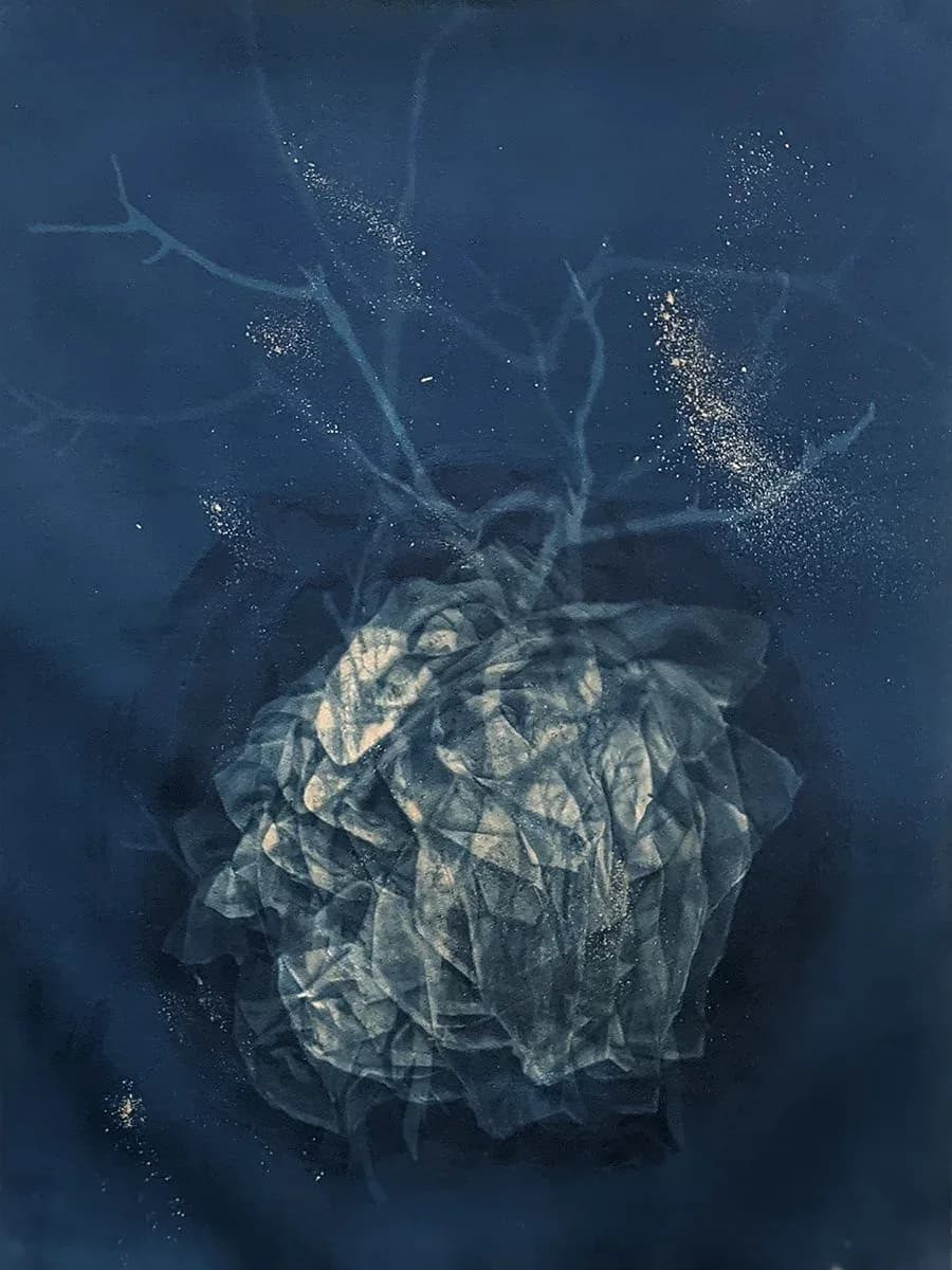 Abstract mixed-media artwork depicting a celestial form with radiating tendrils and sparkling light particles against deep blue background.