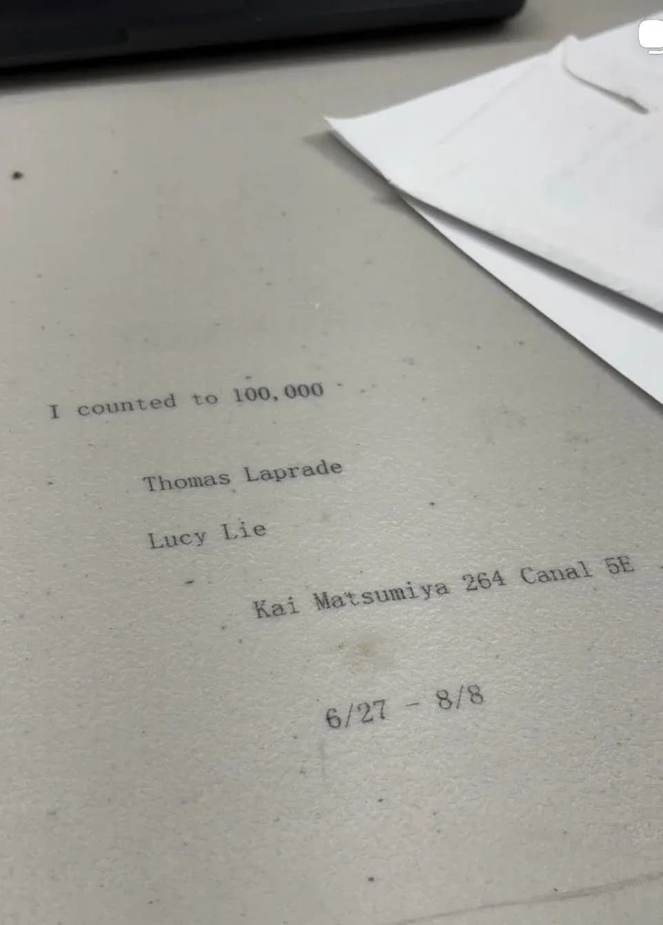 Typed text on cream paper reading "I counted to 100,000" with artist names Thomas Laprade and Lucy Lie, location Kai Matsumiya 264 Canal SE, and dates 6/27–8/8.