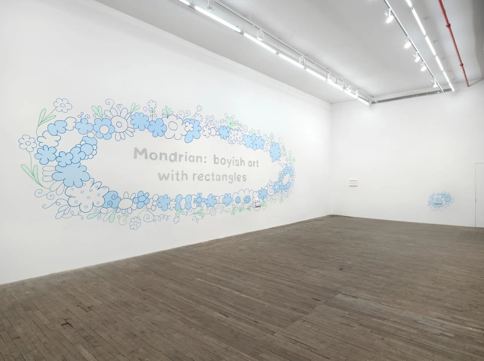 Large-scale wall drawing with blue and gray circular organic forms arranged in an oval shape, with text reading "Mondrian: boyish and with rectangles."