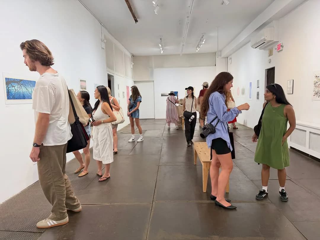 Interior of Kentler International Drawing Space gallery with visitors viewing artworks on white walls and dark flooring.