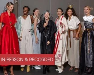 Group of seven people in formal and traditional attire posed together indoors; red banner labeled 'IN-PERSON & RECORDED'.