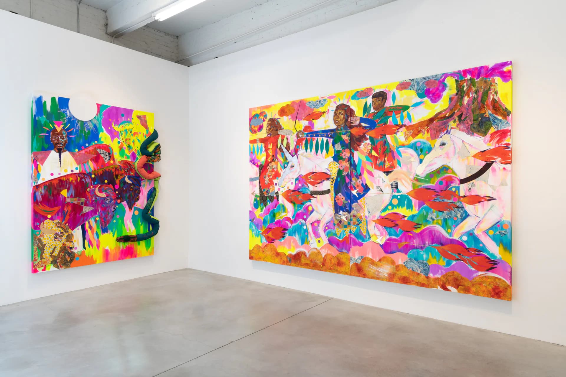 Two large vibrant mixed-media paintings with explosive bursts of neon colors including magenta, yellow, blue, and green, displayed in a gallery corner.