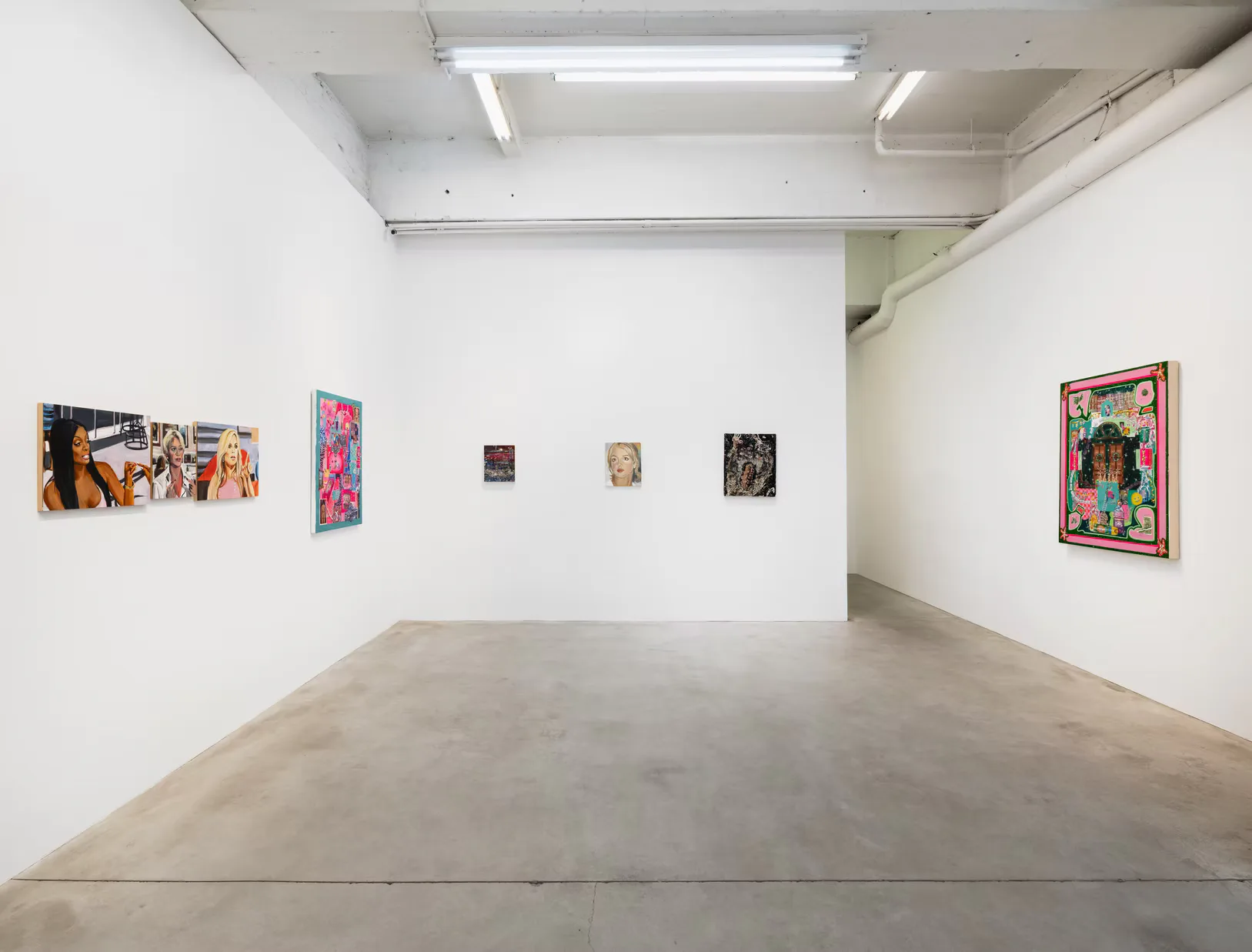 Kravets Wehby Gallery interior with white walls, polished concrete floor, ceiling lights, and various mixed-media artworks displayed at different scales.