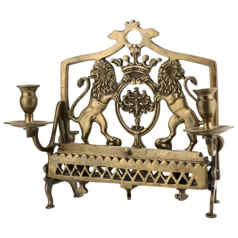 Brass fireplace fender with heraldic design featuring two rampant lions, crown, and decorative lattice work in classical style.