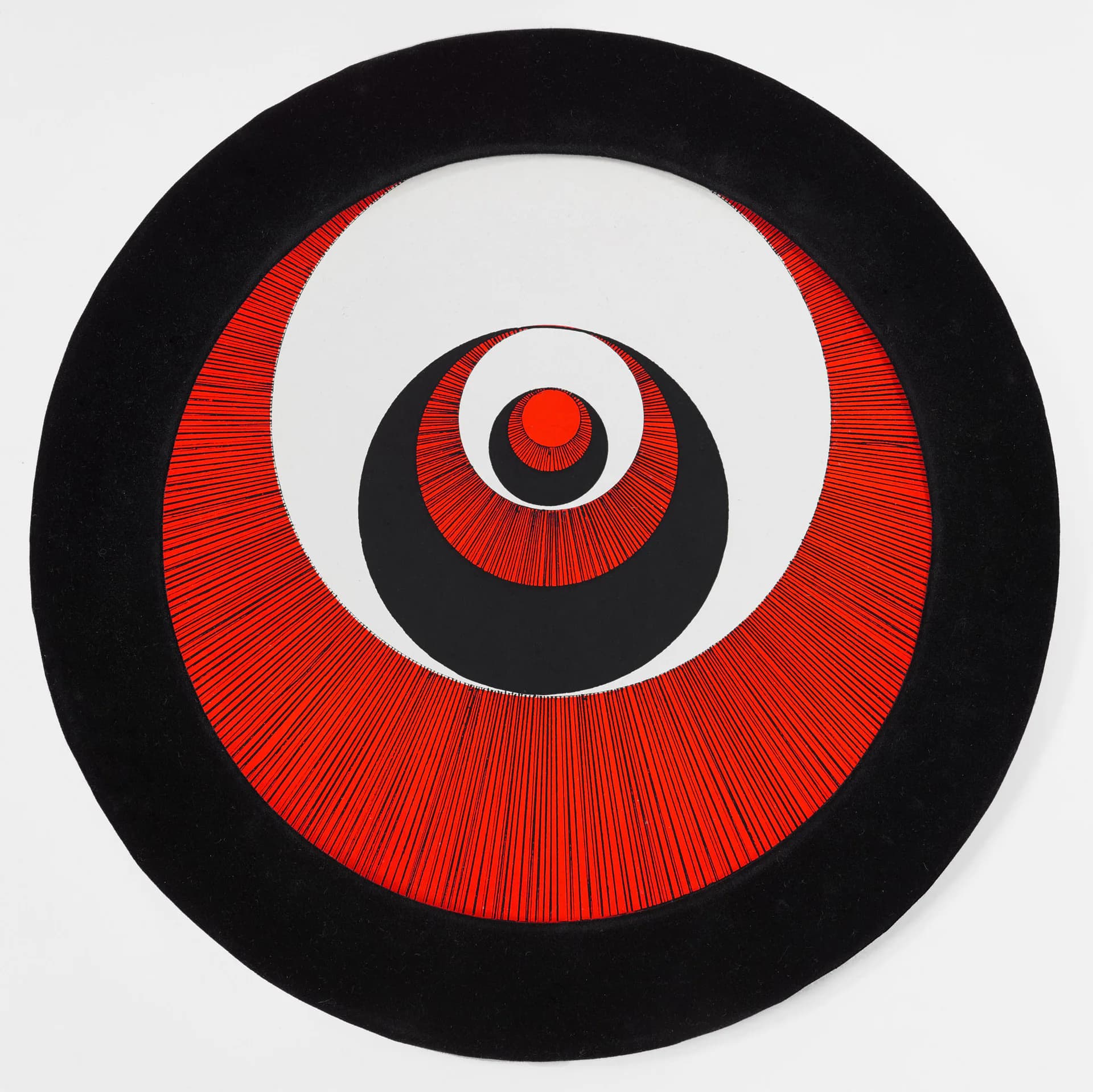 Concentric circles in black, white, and red with radiating line patterns forming a hypnotic target-like composition.