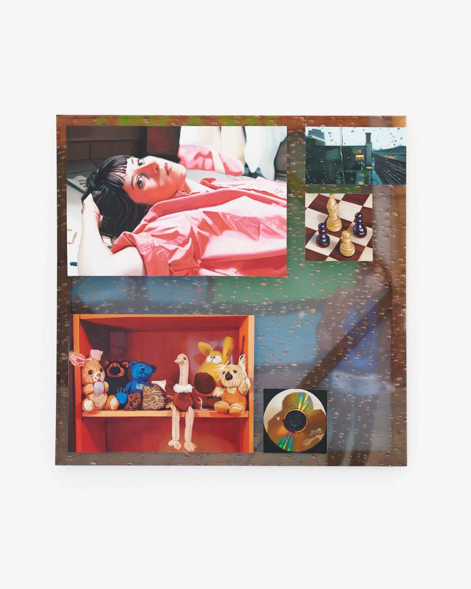 Mixed-media collage on weathered brown wood featuring photographs, a red shelf with figurines, toys, and a CD, with nature and portrait imagery.
