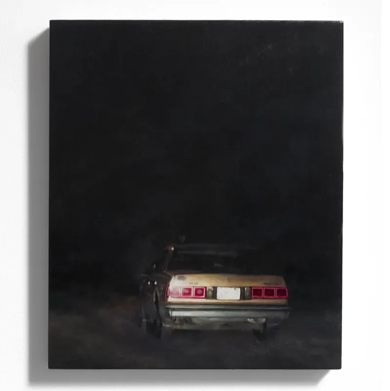 Dark photograph or painting of a vintage car with red and white taillights emerging from black darkness.