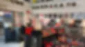 Blurred photo of visitors browsing exhibits inside the New York City Fire Museum, with dark fire apparatus and equipment on display