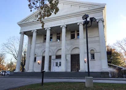 Exterior of a neoclassical white building with tall columns and a pediment, likely Newhouse Center for Contemporary Art at Snug Harbor.