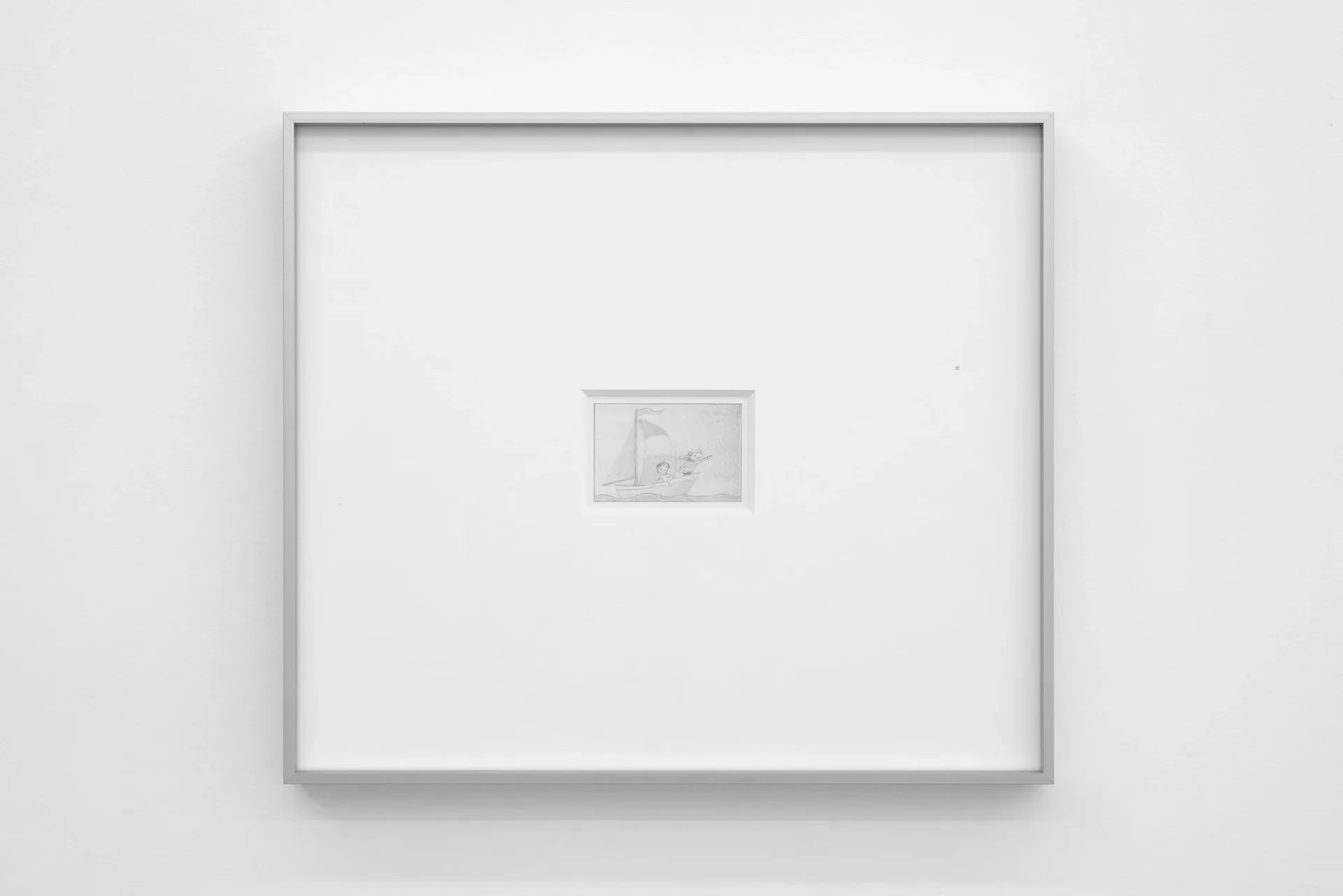 Gallery wall with white matting and gray frame displaying a small framed artwork centered on the wall.