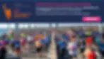 Wide banner photo of a crowd of runners at an outdoor race event with promotional text overlay and a pink button