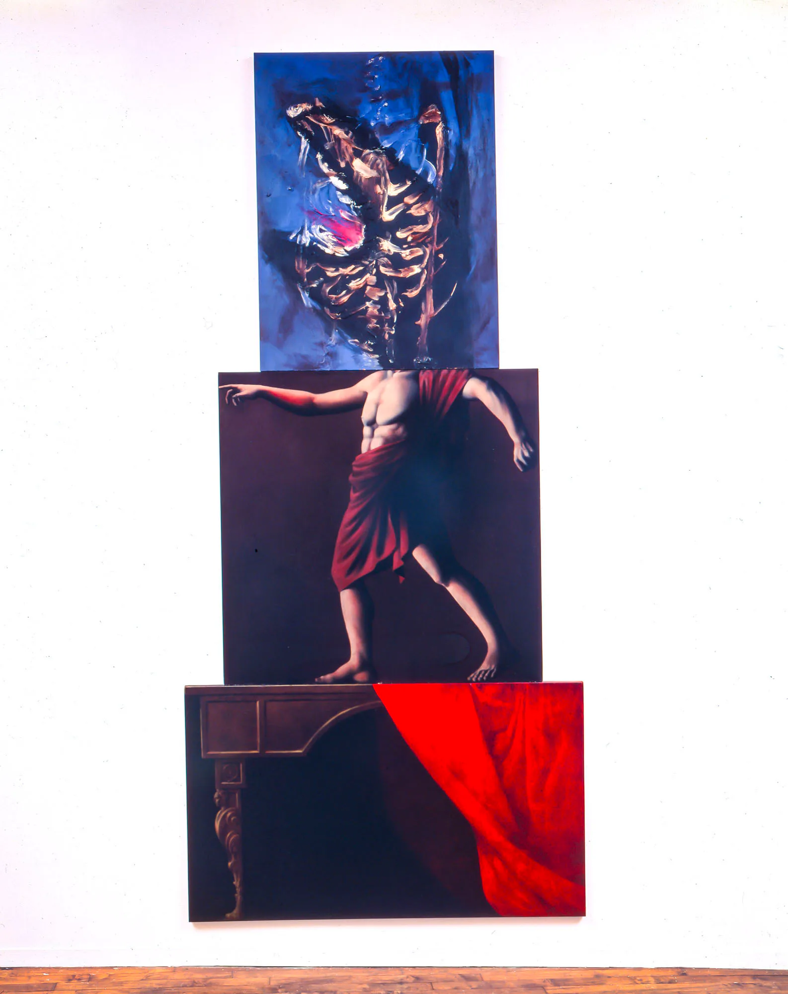 Stacked mixed-media installation with three horizontal panels: abstract blue and black forms atop, central figure in red fabric in motion, and dark lower section with red drape.
