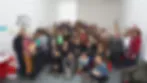 Large group of people posing together for a photo inside a bright studio space at RPGA Studio