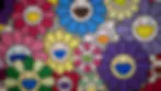 Abstract digital artwork featuring colorful circular and gear-like forms in vibrant pink, yellow, green, and blue on a blurred purple background.