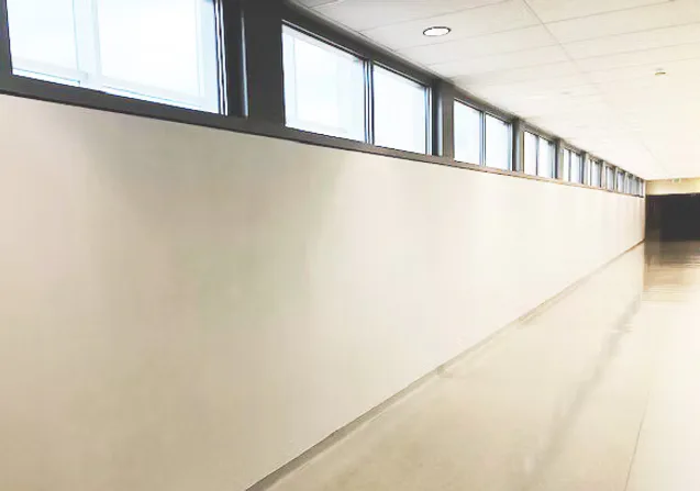 Minimalist RX Art gallery corridor with white walls, long horizontal window strip, polished concrete floor, and institutional lighting.