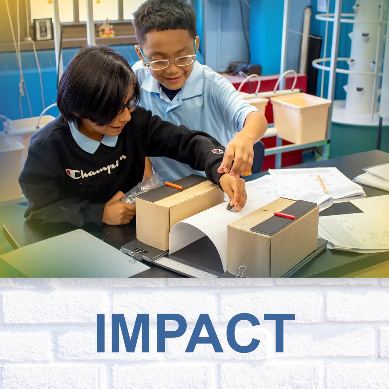 Two children assembling wooden boxes at a table in a colorful classroom; text reads 'IMPACT' at bottom over brick background.
