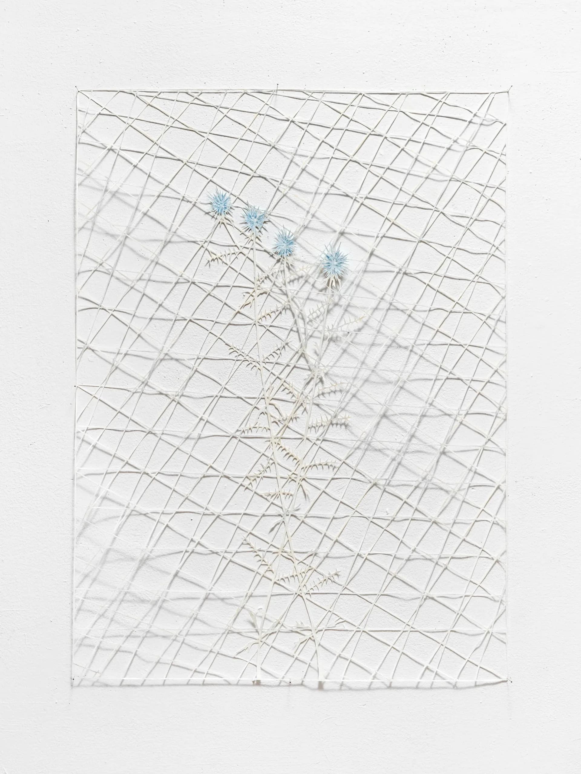 Mixed-media work combining graphite grid with delicate botanical drawings and blue flower symbols scattered throughout, creating layered geometric and organic composition.
