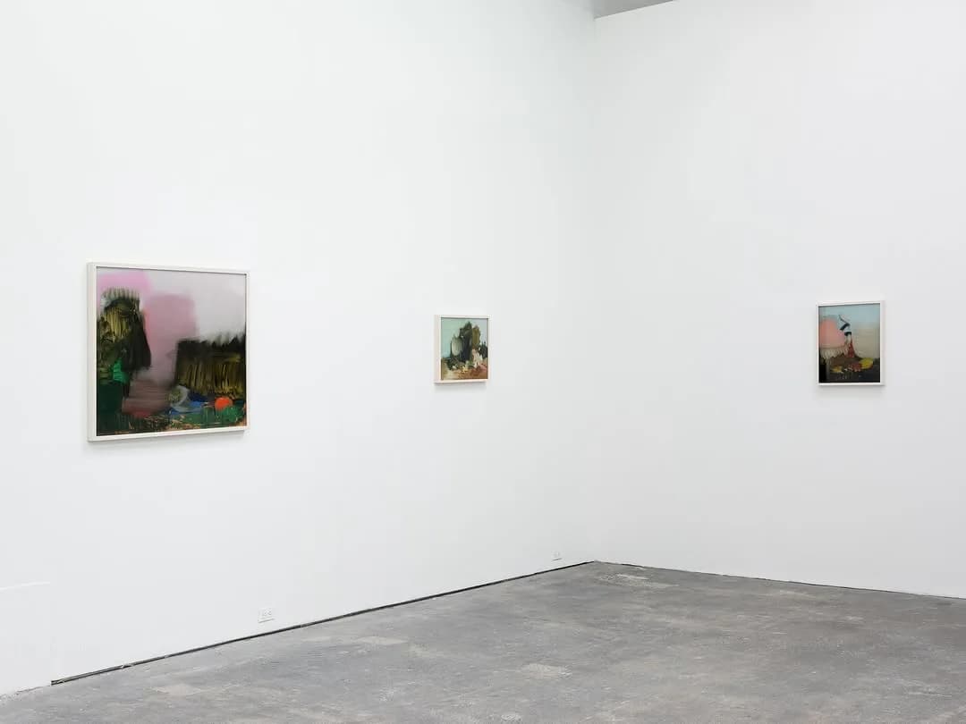 White gallery interior at Spencer Brownstone Gallery with three artworks of varying sizes hung on walls, concrete floor visible.