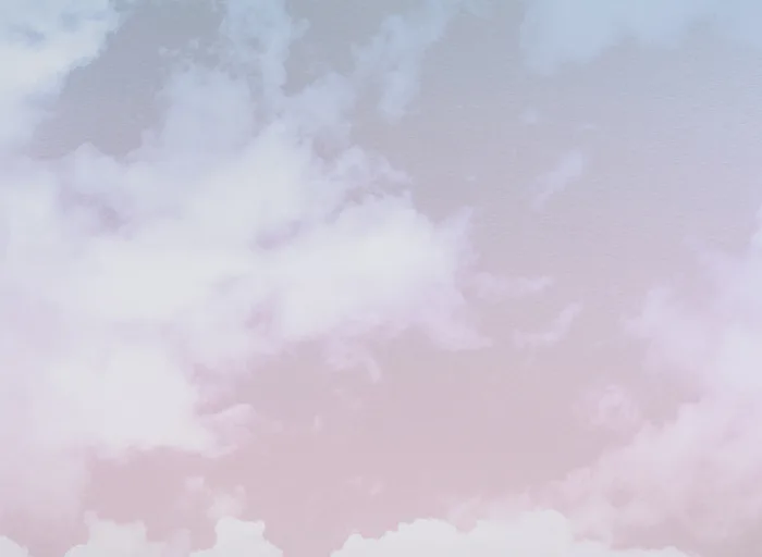 Abstract soft-focus composition of lavender and white clouds against pale pink sky.
