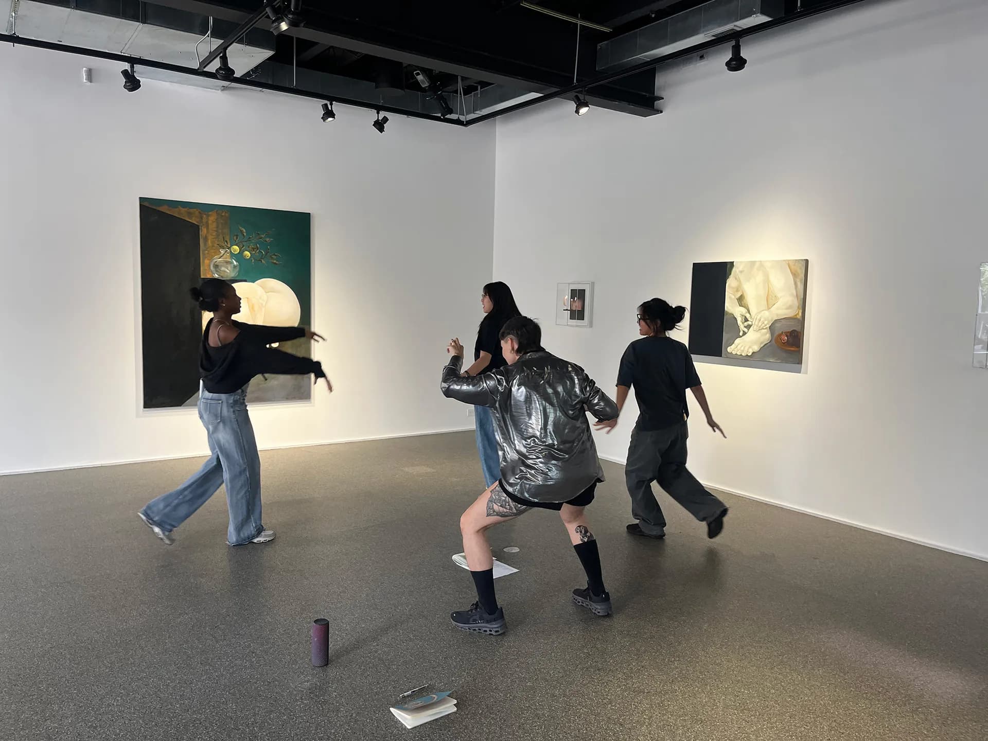 Gallery interior at Swiss Institute with white walls, polished concrete floor, and framed artworks displayed; visitors moving through the space.