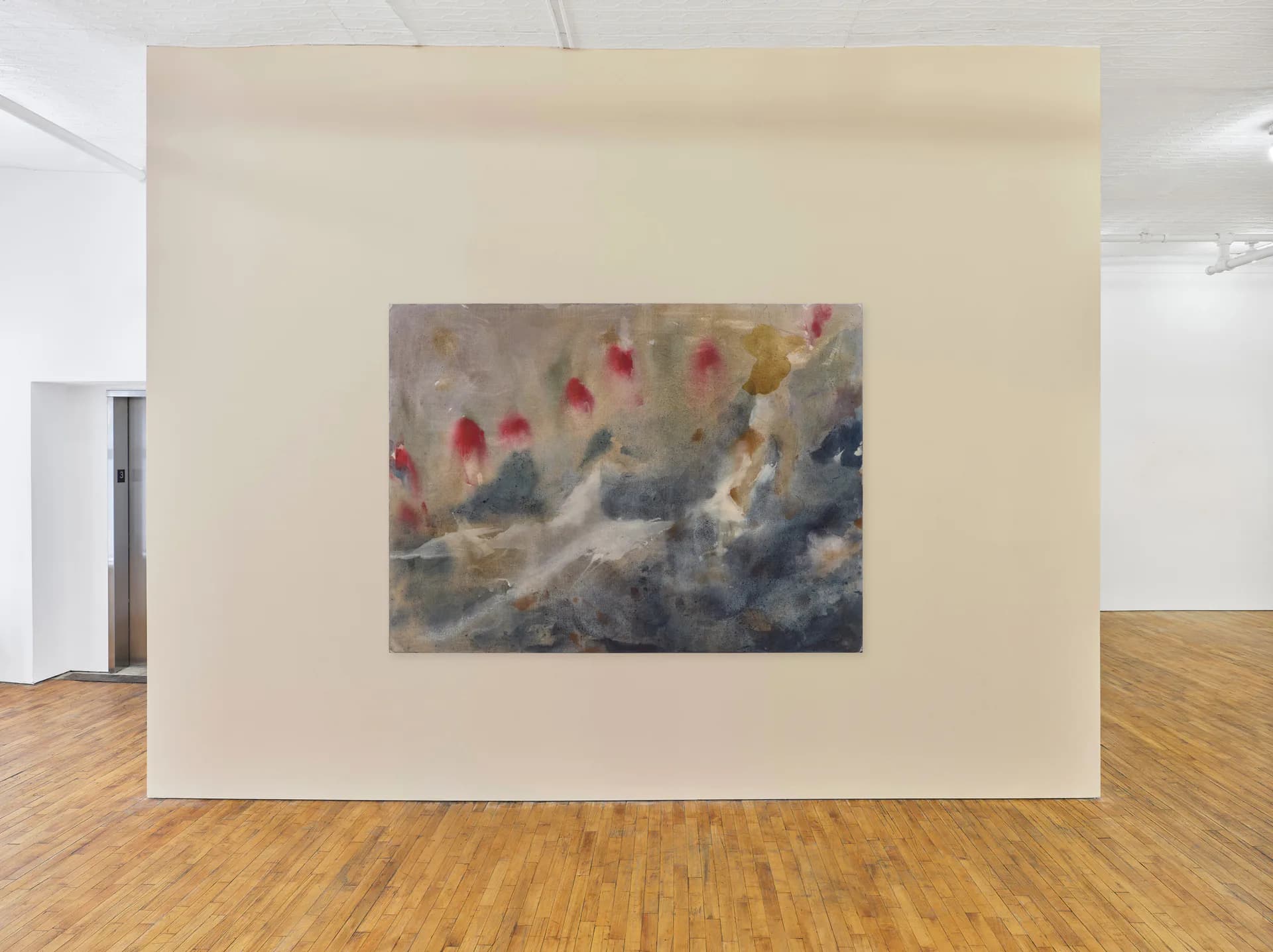 Gallery interior with cream-colored wall featuring a framed mixed-media artwork with red, gold, and blue tones depicting an abstracted crowd scene.