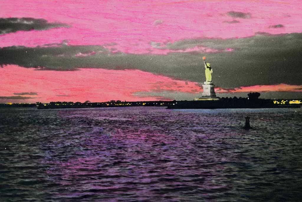 Statue of Liberty silhouetted against vibrant pink and purple sunset sky over water, dramatic chromatic landscape photograph.