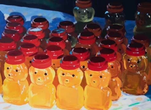 Still-life photograph of honey bear squeeze bottles arranged in rows with red caps and golden honey against blue background.