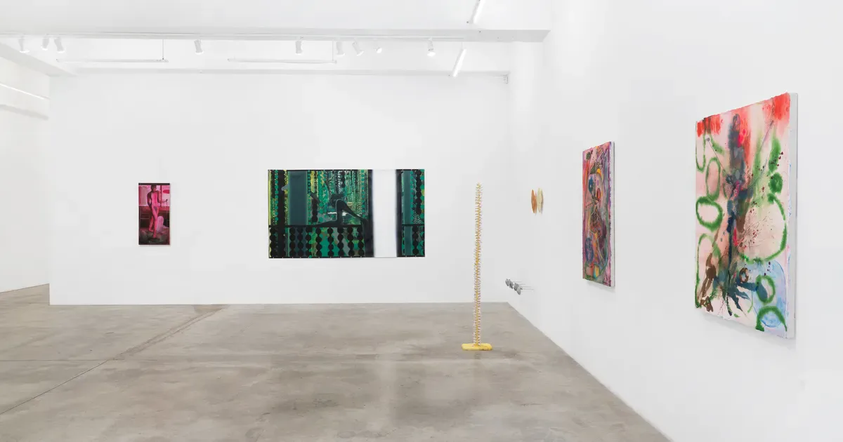 Gallery interior at Tina Kim Gallery with white walls displaying abstract paintings at varying heights, polished concrete flooring, minimal installation.
