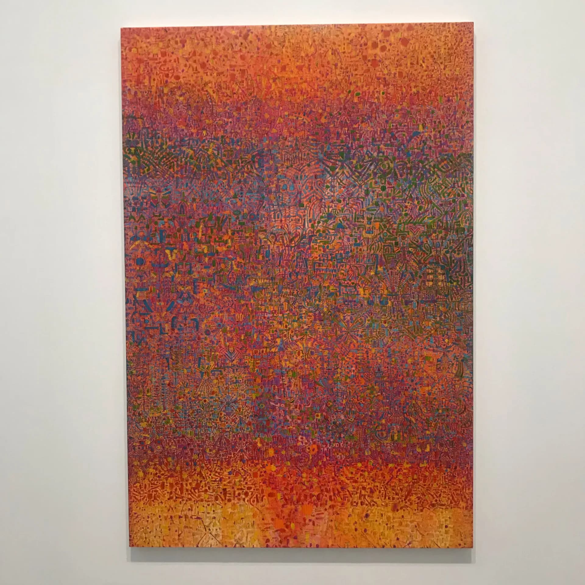 Abstract mixed-media painting with dense textured surface in warm orange, red, and purple tones graduating from darker top to lighter bottom.