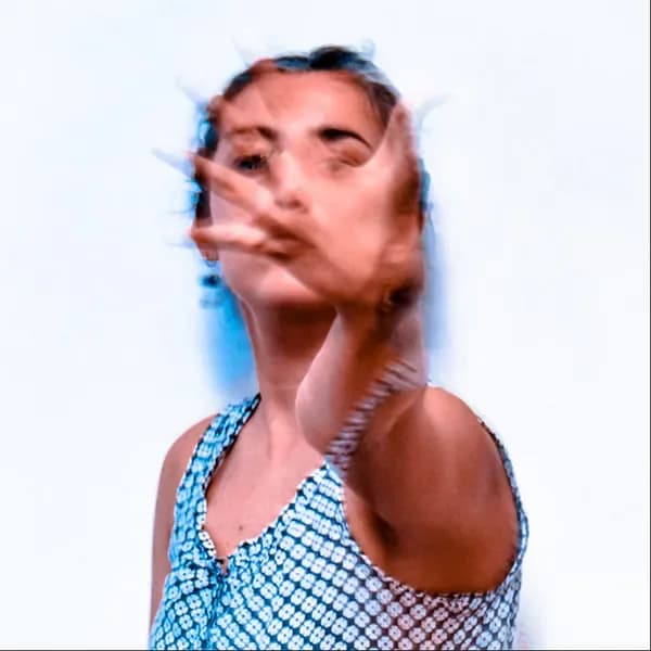 Digital portrait of a person's face with distorted, glitchy color separation effects in blue, red, and flesh tones, creating a fragmented contemporary aesthetic.
