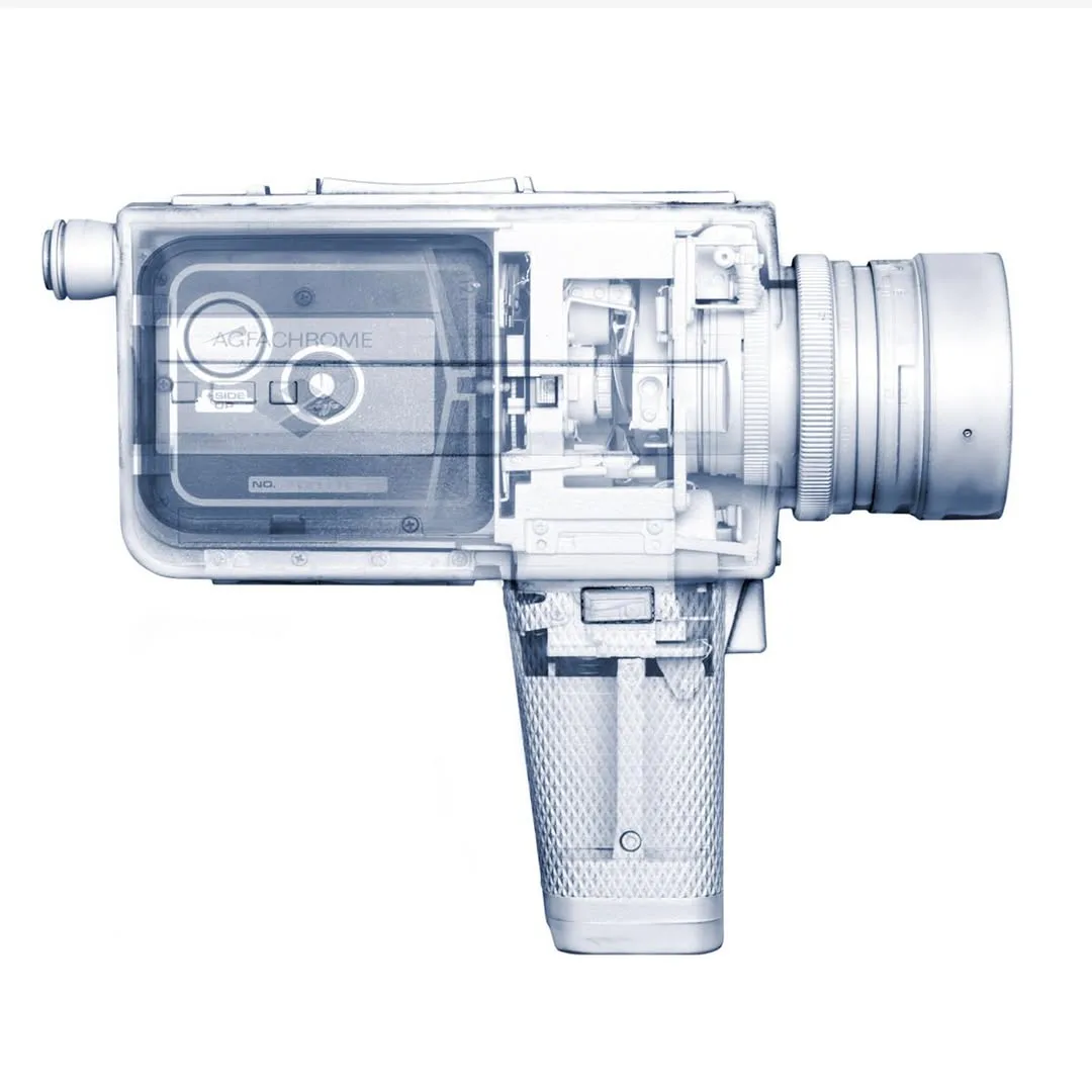 X-ray style technical illustration of a vintage film camera showing internal mechanical components in blue and white tones.